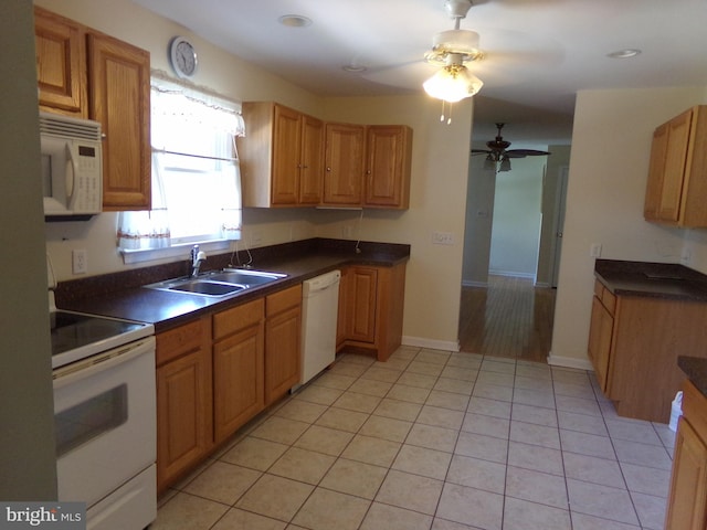 kitchen with light tile patterned flooring, sink, ceiling fan, and white appliances