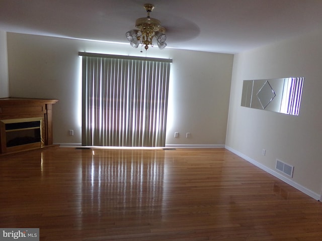 unfurnished living room with hardwood / wood-style flooring and ceiling fan