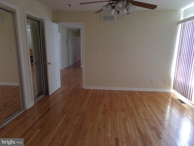 empty room with ceiling fan and light wood-type flooring