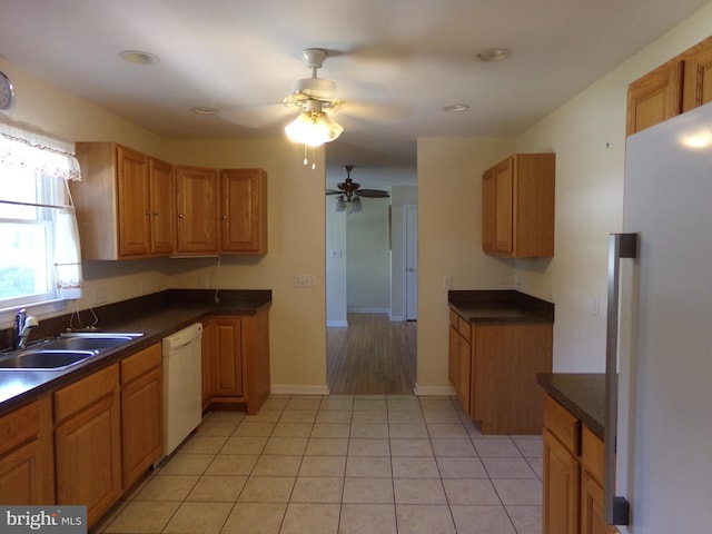 kitchen with sink, light tile patterned floors, ceiling fan, and white appliances