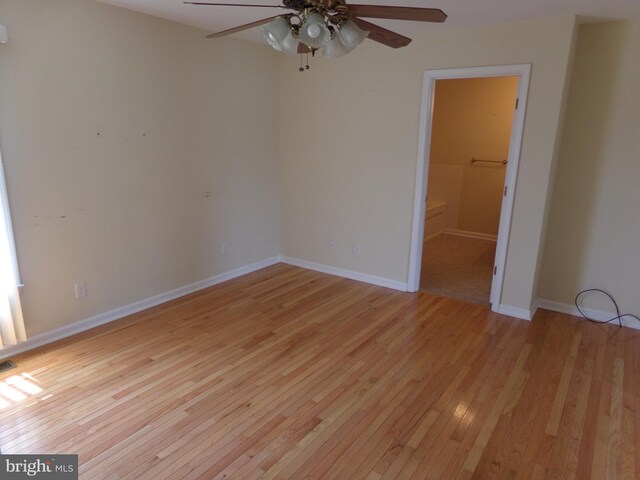 empty room with light wood-type flooring and ceiling fan