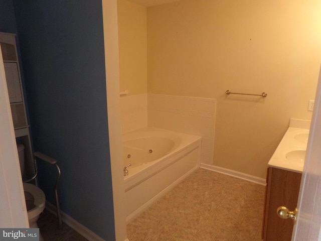 bathroom featuring dual vanity, tile patterned flooring, a tub to relax in, and toilet