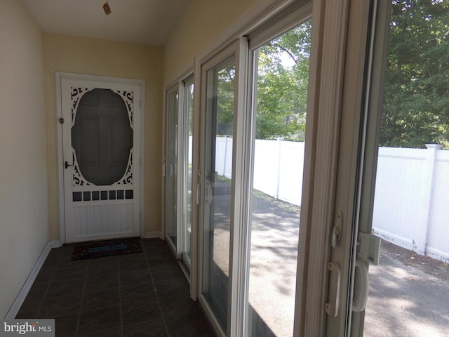 entryway with dark tile patterned flooring