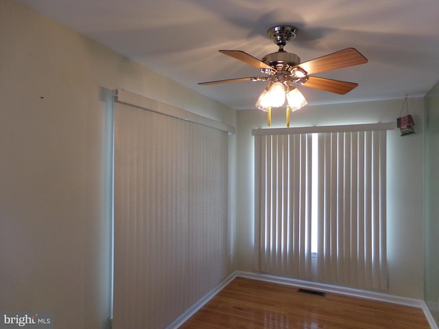 unfurnished room with ceiling fan and hardwood / wood-style flooring