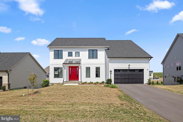 view of front of property with a garage and a front yard