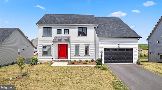 view of front of home featuring a garage and a front yard