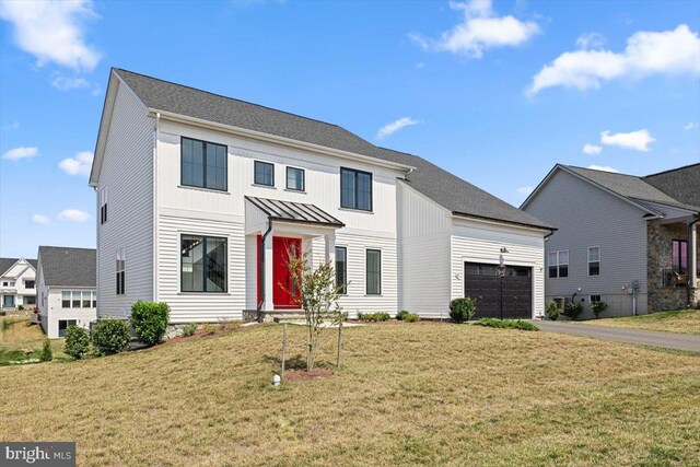 view of front facade featuring a garage and a front lawn