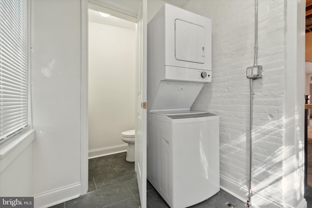 laundry room with stacked washer / drying machine