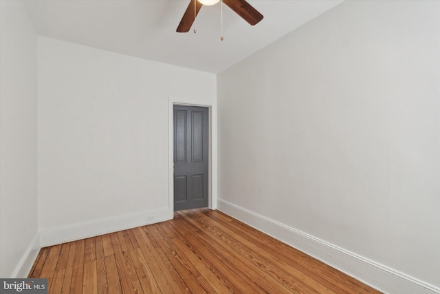 empty room with ceiling fan and hardwood / wood-style flooring