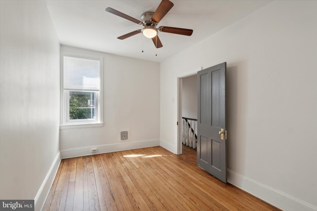 empty room featuring ceiling fan and light hardwood / wood-style floors