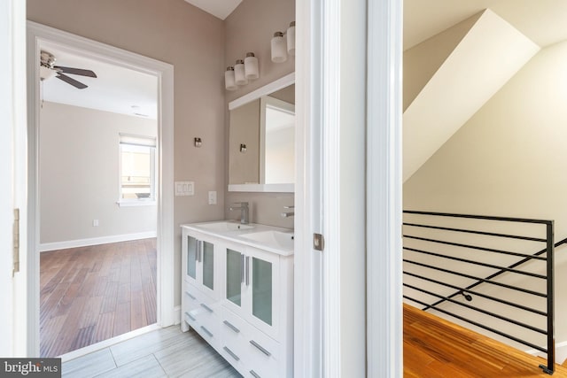 bathroom with hardwood / wood-style flooring, vanity, and ceiling fan