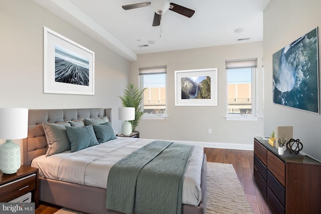 bedroom featuring multiple windows, wood-type flooring, and ceiling fan