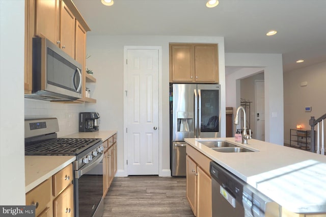 kitchen with sink, dark hardwood / wood-style flooring, decorative backsplash, stainless steel appliances, and a center island with sink