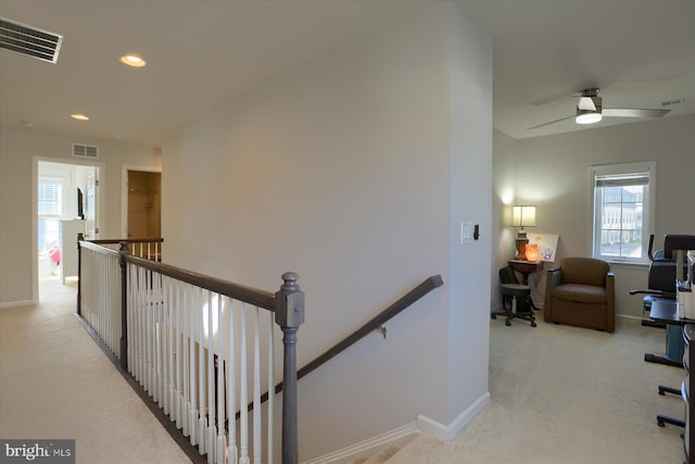 hall featuring light colored carpet