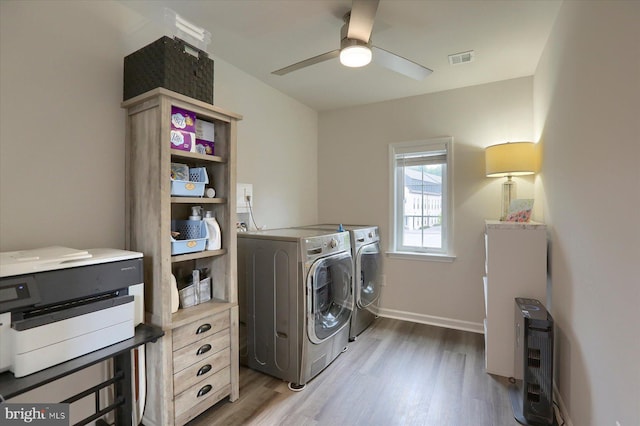 laundry area with ceiling fan, independent washer and dryer, and hardwood / wood-style floors