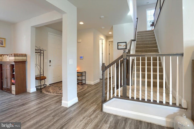 staircase with wood-type flooring