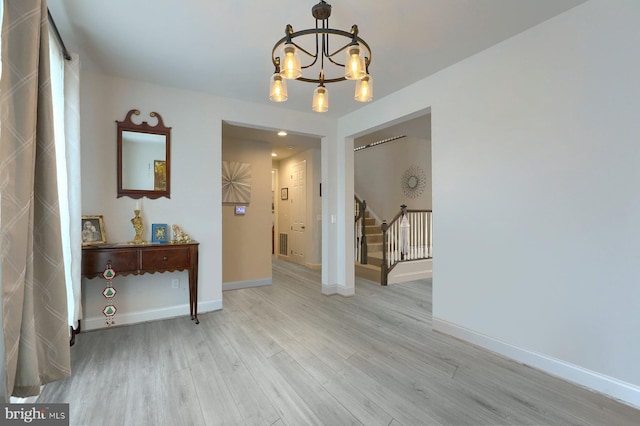 interior space with a chandelier and light wood-type flooring