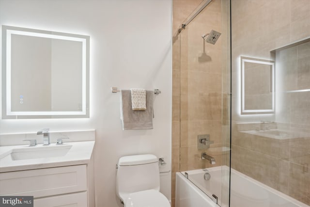 full bathroom featuring vanity, enclosed tub / shower combo, and toilet