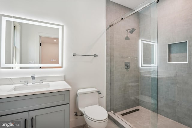 bathroom with vanity, toilet, and walk in shower