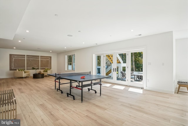 playroom with light hardwood / wood-style floors and french doors