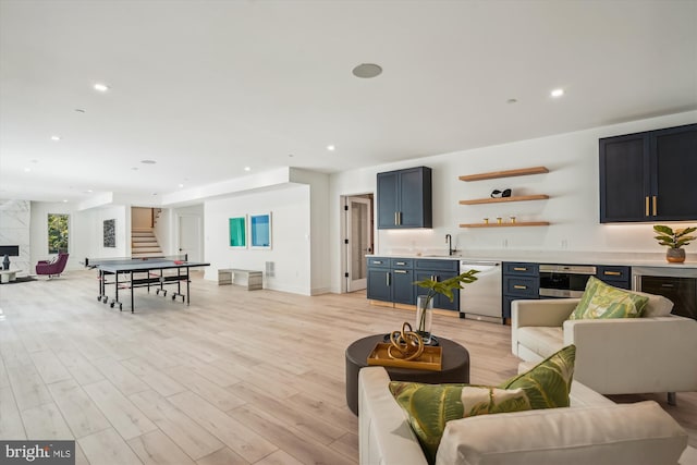 living room with indoor wet bar and light wood-type flooring