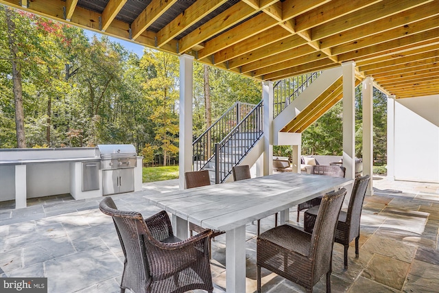 view of patio featuring area for grilling and a grill