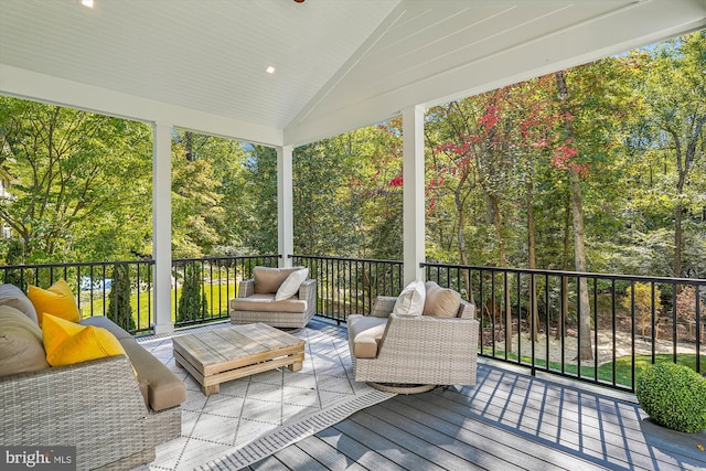 sunroom / solarium featuring lofted ceiling