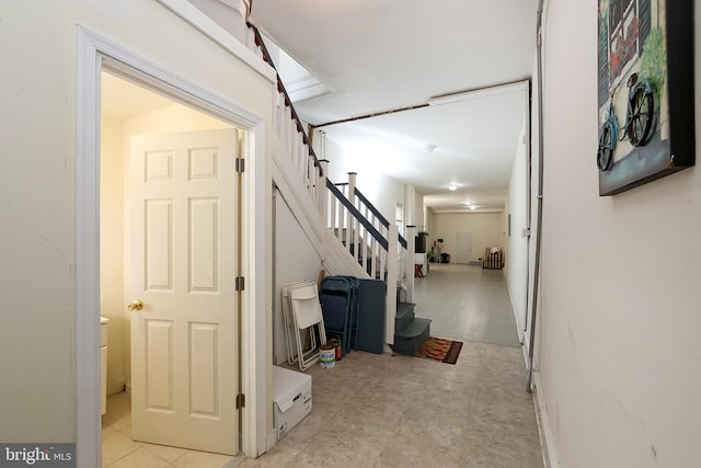 hall featuring light tile patterned floors