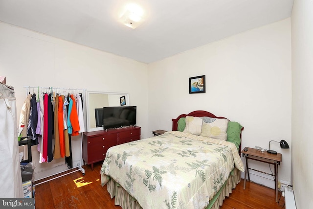 bedroom featuring dark hardwood / wood-style flooring and a baseboard radiator