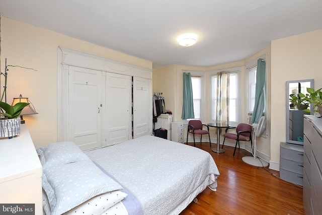 bedroom with hardwood / wood-style flooring and a closet