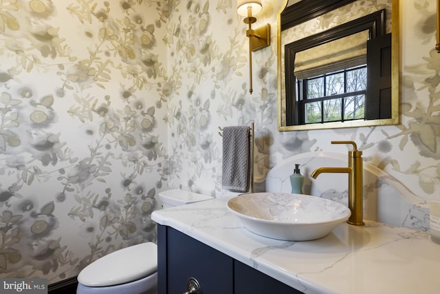 bathroom featuring vanity and toilet