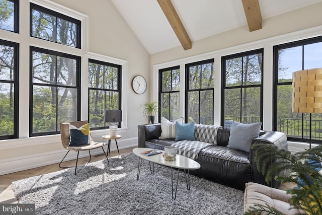 sunroom with vaulted ceiling with beams