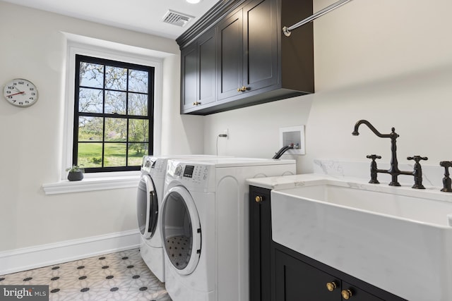 laundry area featuring cabinets, light tile patterned floors, and independent washer and dryer