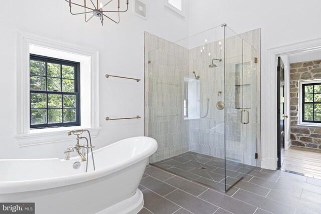 bathroom featuring independent shower and bath, tile patterned flooring, and plenty of natural light