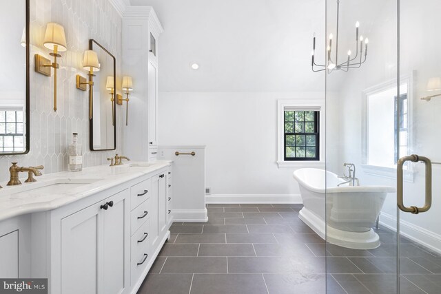 bathroom with tile patterned floors, double sink vanity, and a bathing tub