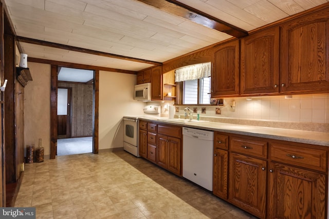 kitchen with decorative backsplash, white appliances, sink, beam ceiling, and light tile patterned floors