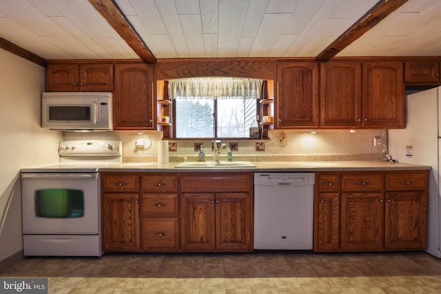 kitchen with tasteful backsplash, white appliances, sink, beam ceiling, and light tile patterned floors