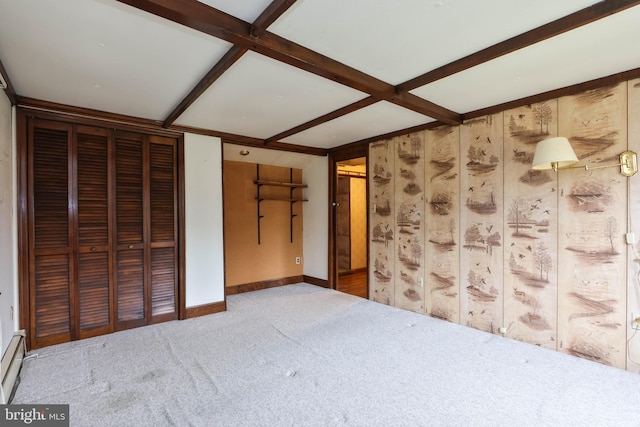 unfurnished bedroom with carpet floors, beam ceiling, and coffered ceiling