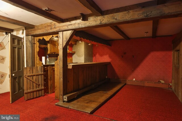 basement featuring a baseboard heating unit and carpet flooring