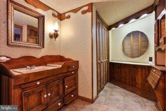 bathroom featuring vanity, a textured ceiling, and tile patterned flooring