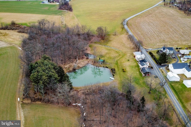 drone / aerial view featuring a water view and a rural view