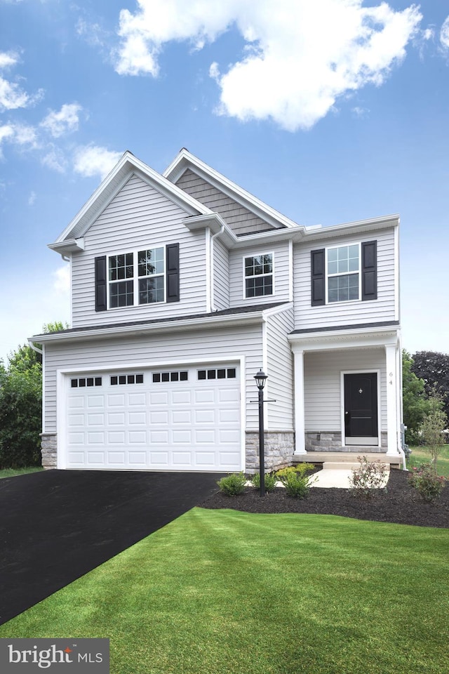 view of front of home featuring a garage and a front lawn