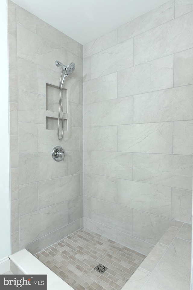 bathroom with tiled shower