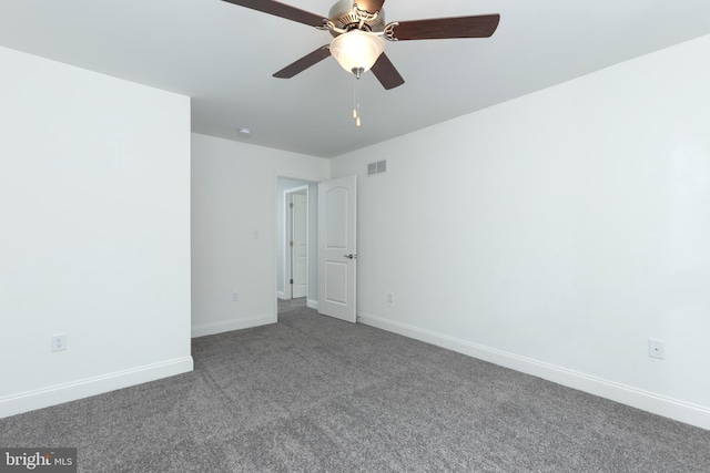 carpeted spare room with ceiling fan