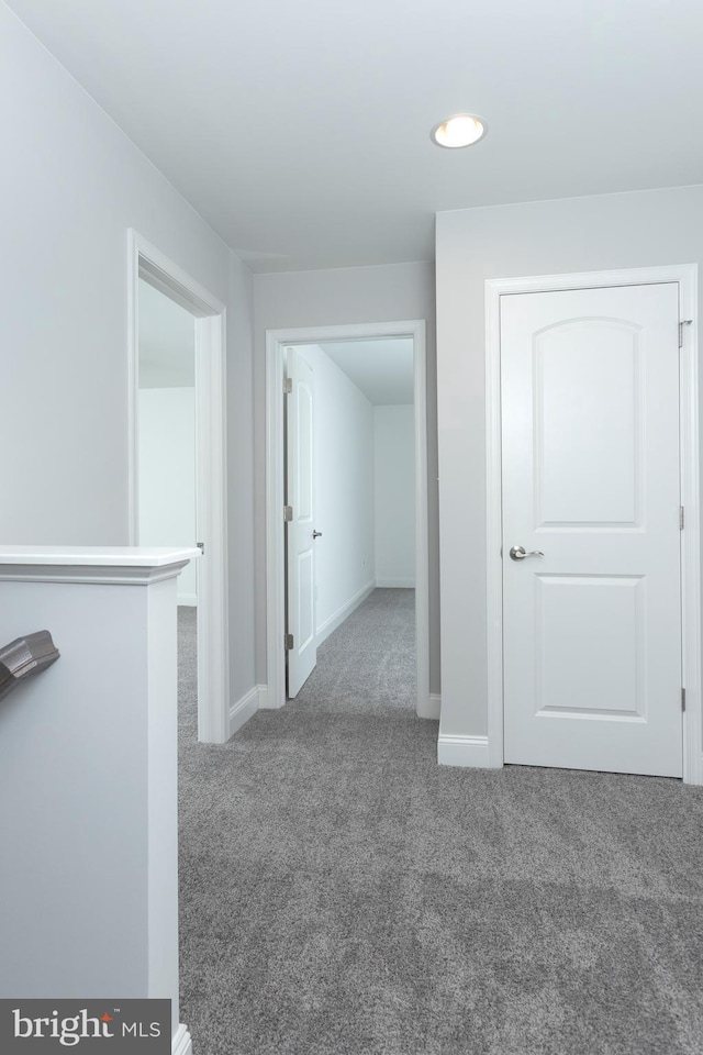 hallway with carpet floors