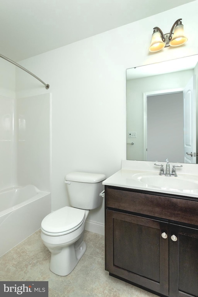 full bathroom with vanity, tile patterned floors, washtub / shower combination, and toilet