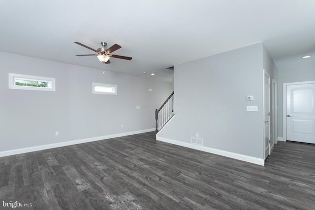 unfurnished room with dark wood-type flooring and ceiling fan