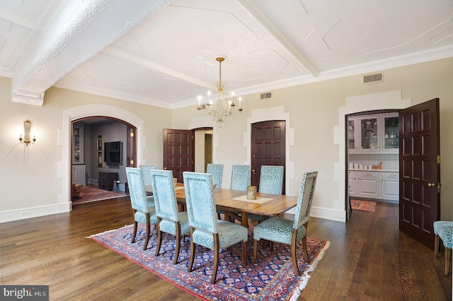 dining area with crown molding, dark wood-type flooring, and a notable chandelier