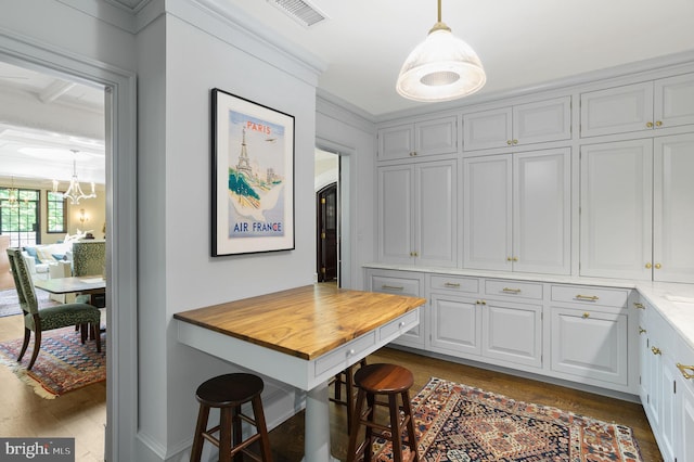 dining area with an inviting chandelier and dark wood-type flooring