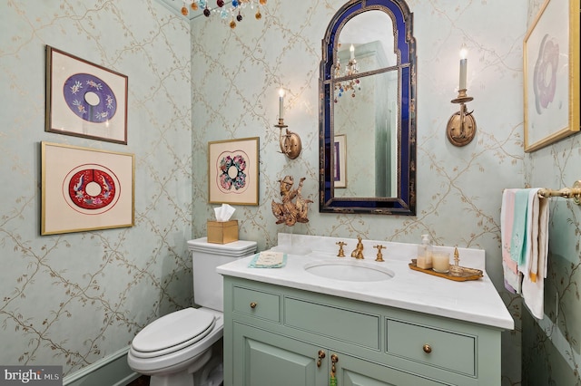 bathroom featuring vanity and toilet